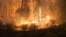 Fire burns close to a highway near Sorrento, British Columbia, Canada, on Aug. 18, 2023, in this screen grab obtained from social media video. (Nikki Goyer via REUTERS)