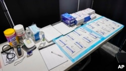 COVID tests are set up inside the medical intake tent at a shelter in New York on Aug. 15, 2023. Health authorities are monitoring a new variant of COVID, the World Health Organization announced on Aug. 18, 2023.