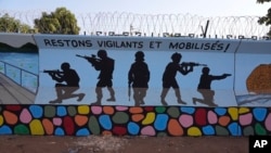 FILE - A mural is seen in Ouagadougou, Burkina Faso, March 1, 2023. Three survivors of an attack in Zaongo, central Burkina Faso, told AP that dozens of people were killed in their village on Nov. 5 when security forces attacked.