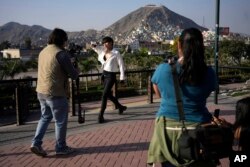 Peruvian singer Lenin Tamayo strikes a pose while recording a music video in Lima, Peru, Aug. 3, 2023.