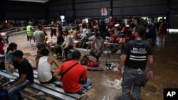 FILE - Migrants from Venezuela wait for transportation to continue on their way north to Nicaragua and hopefully to the Mexico-United States border, at a Migrant Temporal Attention Center in Paso Canoas, Costa Rica, Oct. 16, 2023.