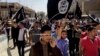 FILE - Demonstrators chant pro-Islamic State slogans in Mosul, Iraq, on June 16, 2014. The Islamic State announced on Aug. 3, 2023, the death of Abu Hussein al-Husseini al-Quraishi, who had been the extremist organization's leader since November.