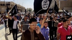 FILE - Demonstrators chant pro-Islamic State slogans in Mosul, Iraq, on June 16, 2014. The Islamic State announced on Aug. 3, 2023, the death of Abu Hussein al-Husseini al-Quraishi, who had been the extremist organization's leader since November.