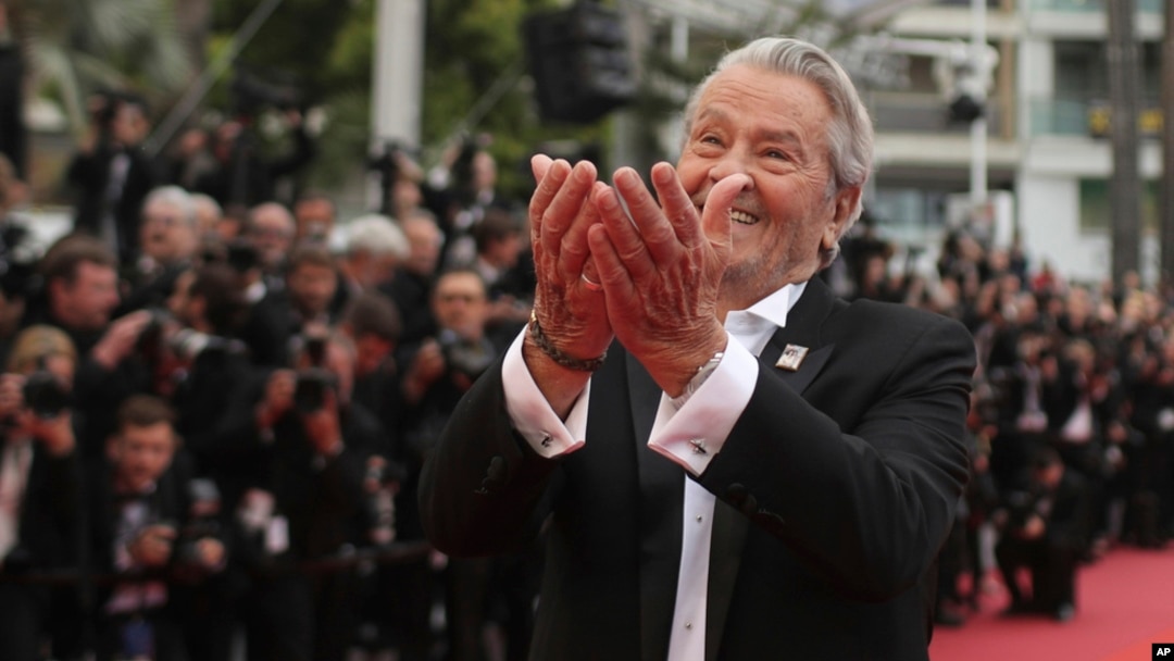 FILE - In this May 19, 2019, photo, French actor Alain Delon poses for photographers upon arrival at the premiere of the film 'A Hidden Life' at the 72nd international film festival, Cannes, southern France. 
