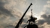 FILE - Crews work to remove a monument to the Confederacy, a towering statue of Confederate Gen. Robert E. Lee, in Richmond, Virginia, Sept. 8, 2021. A Black-owned Richmond company has been chosen to revitalize the site where the statue stood.