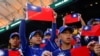 FILE - Baseball players hold the Taiwanese flag while waiting for the match between Taiwan and Panama in the 2023 World Baseball Classic game in Taichung, Taiwan March 8, 2023. 