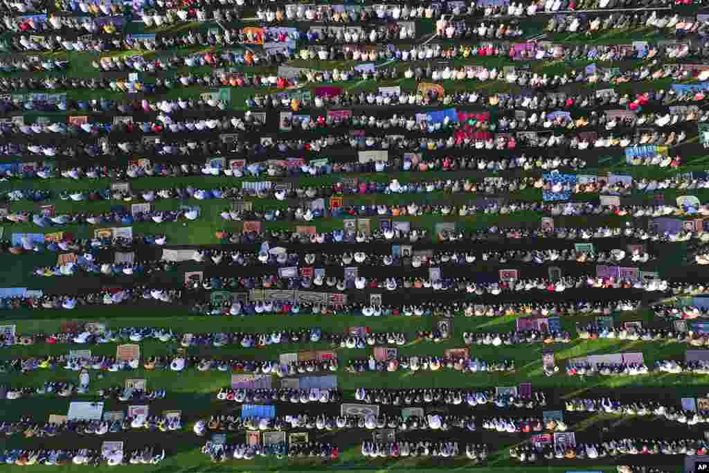 People attend Eid al-Fitr prayer at a stadium in the city of Idlib, Syria.