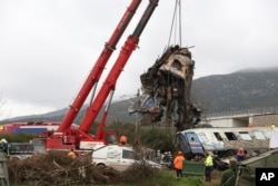 Cranes remove debris after a trains' collision in Tempe, about 376 kilometres (235 miles) north of Athens, near Larissa city, Greece, March 2, 2023.