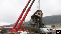 Cranes remove debris after a trains' collision in Tempe, about 376 kilometres (235 miles) north of Athens, near Larissa city, Greece, March 2, 2023. 