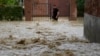 A man walks in a flooded street in the village of Castel Bolognese, Italy, May 17, 2023. 