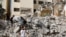 Palestinian children walk amidst the rubble of damaged buildings in the aftermath of an Israeli raid on Jenin camp in the Israeli-occupied West Bank, May 23, 2024. 