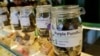 FILE - Jars containing marijuana are seen at Royal Queen Seeds, a cannabis shop in Bangkok, Nov. 17, 2022. 