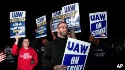 Striking United Auto Workers picket at Ford's Michigan Assembly Plant in Wayne, Mich., shortly after midnight Sept. 15, 2023. 