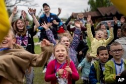 Children dance at the recovery camp for children and their mothers affected by the war near Lviv, Ukraine, Wednesday, May 3, 2023.