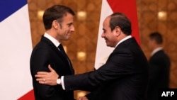 Presiden Prancis Emmanuel Macron (kiri) dan Presiden Mesir Abdel-Fattah El-Sisi berjabat tangan di akhir konferensi pers bersama di Kairo, pada 25 Oktober 2023. (Foto: Christophe Ena/Pool/AFP)
