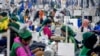 FILE - Garment employees work in a sewing section of the Snowtex Outerwear Ltd. factory in Savar, Bangladesh, Aug. 9, 2021.