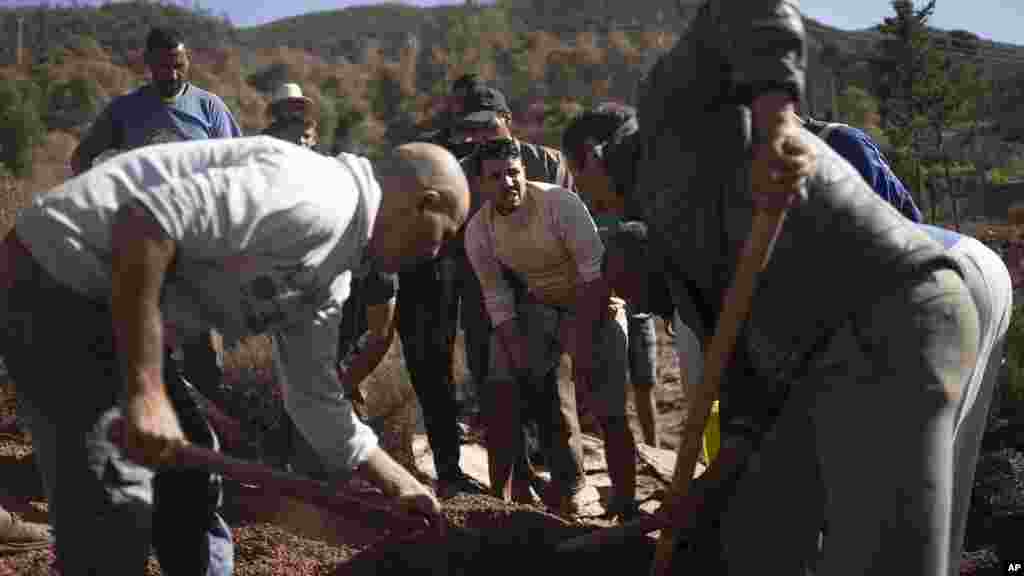 People dig a grave to bury bodies of earthquake victims in Ouargane village, near Marrakech, Morocco, Sept. 9, 2023. 