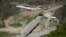 FILE - A bridge and a checkpoint are seen on a road towards the separatist region of Nagorno-Karabakh in Armenia, July 28, 2023. 