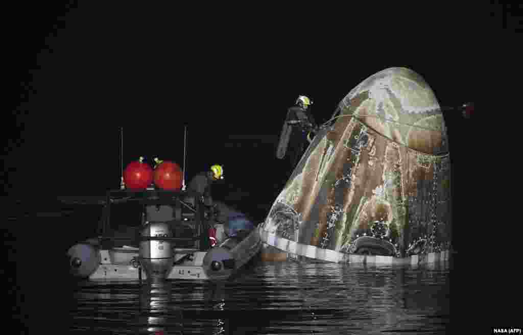 Support teams work around the SpaceX Dragon Endurance spacecraft shortly after it splashed down with NASA astronaut Jasmin Moghbeli, ESA astronaut Andreas Mogensen, JAXA astronaut Satoshi Furukawa, and Roscosmos cosmonaut Konstantin Borisov, in the Gulf of Mexico off the coast of Pensacola, Florida.