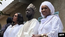 FILE—Presidential candidate for the Diomaye President coalition Bassirou Diomaye Faye (C), and his wives Marie Khone Faye (L) and Absa Faye (R) in Ndiaganiao on March 24, 2024 during Senegal's presidential elections.