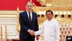 FILE - In this handout photo released by Russian Foreign Ministry Press Service, Myanmar State Administration Council Chairman Senior General Min Aung Hlaing, right, and Russian Foreign Minister Sergey Lavrov pose during their meeting in Naypyitaw, Myanmar, Aug. 3, 2022.