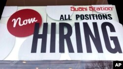 FILE - File - A hiring sign is displayed at a restaurant in Rolling Meadows, Ill., Dec. 27, 2022. On Thursday, the Labor Department reports on the number of people who applied for unemployment benefits last week. 