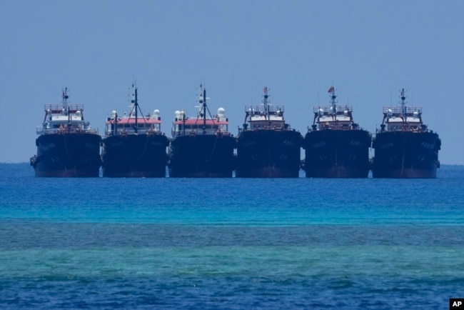 FILE - Six suspected Chinese militia ships lay side by side at the Philippine-claimed reef called Whitsun, at the South China Sea, April 22, 2023.