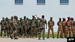 FILE - Burkina Faso (R) and Niger (L) Army soldiers attend the annual US-led Flintlock military training organised by the Internationl Counter-Terrorism Academy in Jacqueville, on March 14, 2023.