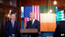 President Joe Biden speaks at the Windsor Bar and Restaurant in Dundalk, Ireland, April 12, 2023. Micheál Martin, Tánaiste of Ireland, listens at left.