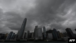 Heavy rain clouds are seen covering Central district in Hong Kong, Oct. 8, 2023, as Typhoon Koinu skirts the financial hub, bringing rains and powerful gusts