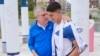 International Olympic Committee President Thomas Bach hugs Israeli soccer player Niv Yehoshua during the inauguration of the Olympic Truce Wall in the Olympic Village at the 2024 Summer Olympics, July 22, 2024, in Paris.
