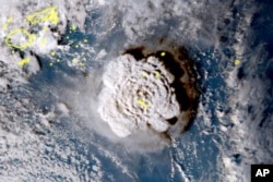 FILE - This satellite image made by the Japanese weather satellite Himawari-8 shows the eruption of the Hunga Tonga-Hunga Ha’apai undersea volcano at the Pacific nation of Tonga, Jan. 15, 2022.