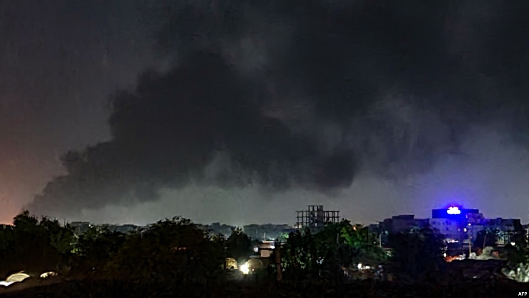 Smoke rises above buildings in Khartoum on May 19, 2023, as violence between two rival Sudanese generals continues.