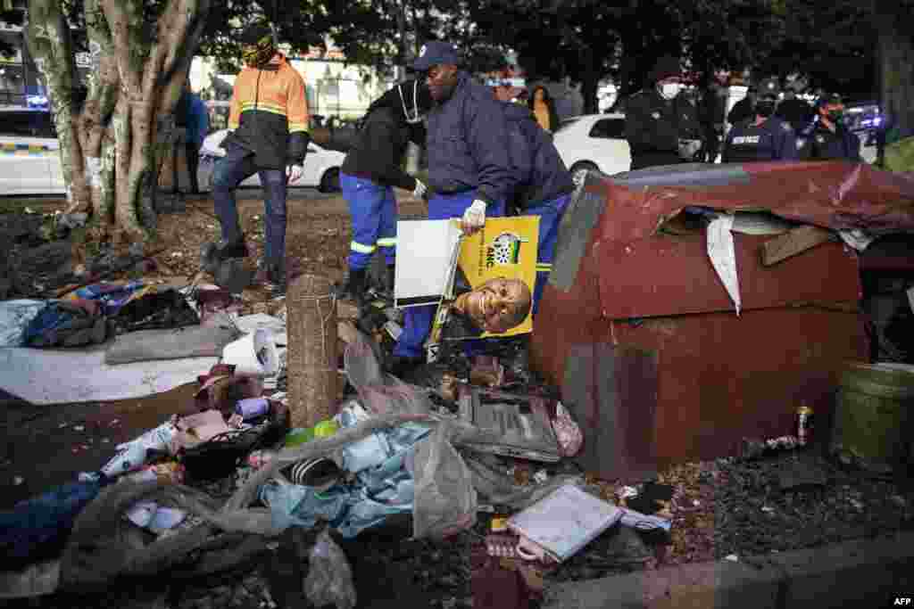 Members of the Cape Town Metro Police Department and employees of the Cape Town City Council remove the structures and belongings of people living illegally on the side of a road in the Cape Town city center.