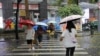 Pedestrians cross a street during a rainstorm in Shenzhen, Guangdong province, China, April 21, 2024 (cnsphoto via Reuters)