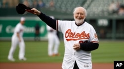 FILE - John Williams waves before throwing out a ceremonial first pitch before a baseball game between the Baltimore Orioles and the Boston Red Sox, June 11, 2018, in Baltimore.