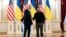 U.S. President Joe Biden shakes hands with Ukrainian President Volodymyr Zelenskiy at Mariinsky Palace on an unannounced visit in Kyiv, Ukraine, Monday, Feb. 20, 2023.