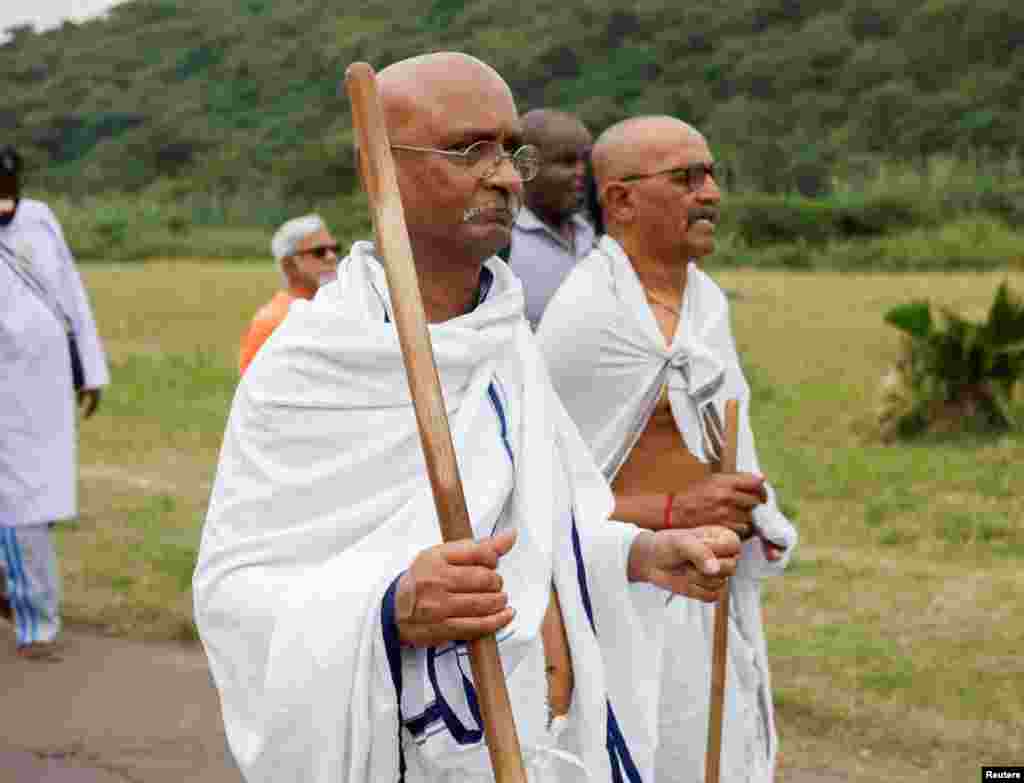 Men dressed as Mahatma Gandhi participate in the annual Salt March in Durban, South Africa.