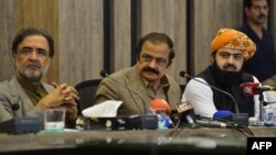 Pakistan Interior Minister Rana Sanaullah, center, listens to a question during a press conference in Islamabad, May 24, 2022.