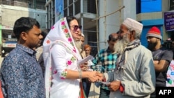 FILE - In this photograph taken on Jan. 4, 2024, transgender candidate Anwara Islam Rani shakes hands with a man during a campaign event in Rangpur, ahead of Bangladesh's general election on Jan. 7. Although unsuccessful, her campaign garnered significant public support.