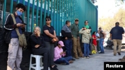 People queue near a polling station during the general election, in Mexico City, June 2, 2024. 