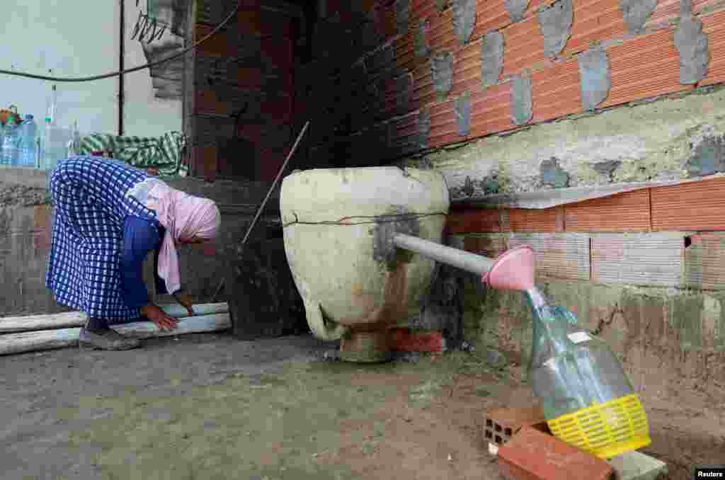 Daouda Ben Salem works on distilling floral water using traditional technique at her home in Nabeul, Tunisia.