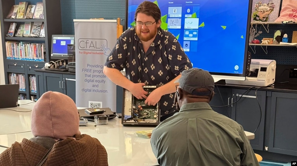 In this undated photo, Richie Hull, a lead instructor at the Connecticut-based group CfAL for Digital Inclusion, teaches participates how to take a computer apart and put it back together again. (Rose Servetnick/CfAL for Digital Inclusion via AP)