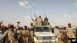FILE - Gen. Mohammed Hamdan Dagalo waves to a crowd in the Nile River state, Sudan, July 13, 2019. Dagalo is the leader of the RSF paramilitary group.