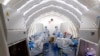 FILE - Staffers work in an inflatable COVID-19 testing lab provided by China's BGI Genomics in Beijing, June 23, 2020. China strongly objected March 3, 2023, after BGI Group and 17 others were hit with curbs on access to U.S. technology. (Xinhua via AP)