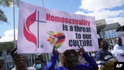 Members of the United Methodist Church in Zimbabwe hold placards while protesting at the church premises in Harare, May 30, 2024. 