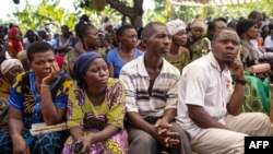 FILE: Mourners gather for funeral of Florence Masika and Zakayo Masereka in Mpondwe on June 18, 2023. Families buried their dead in western Uganda on Sunday while others desperately searched for those still missing after militants killed dozens of students in a school attack.