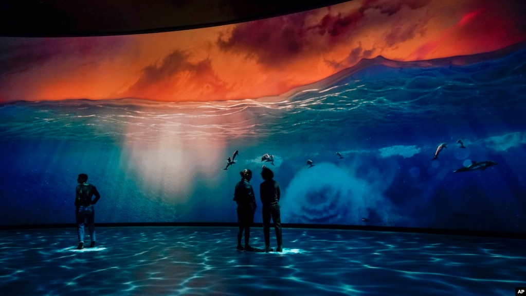FILE - Visitors take in the Invisible Worlds interactive display during a media preview of the Richard Gilder Center for Science, Education and Innovation, Wednesday, April 26, 2023, at the American Museum of Natural History in New York. (AP Photo/Mary Altaffer)