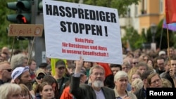 People attend a rally for democracy and against violence on Matthias Ecke, a member of the European Parliament, in Dresden, Germany, May 5, 2024. The placard reads "Stop hate preachers!"