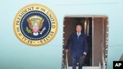 U.S. President Joe Biden walks down the steps of Air Force One upon arrival at Marine Corps Air Station Iwakuni, western Japan, May 18, 2023, en route to Hiroshima for the Group of Seven nations' summit.